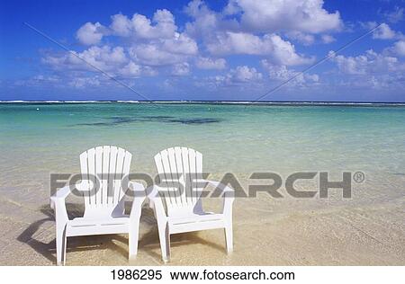 Stock Photography - White Beach Chairs On Beautiful Beach, Clear Turquoise Water.. Fotosearch