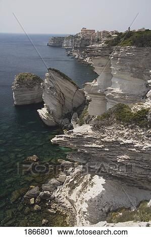 Stock Image - White Cliffs And Rock Formations Along The Coastline; Bonifacio, Corsica, France. Fotosearch