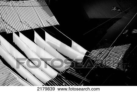 White dyed cloth hanging to dry as a cat walks across a tin roof in the souks; Marrakesh, Morocco View Large Photo Image Stock Photo - White dyed cloth hanging to dry as a cat walks across a tin roof in the souks; Marrakesh, Morocco. Fotosearch