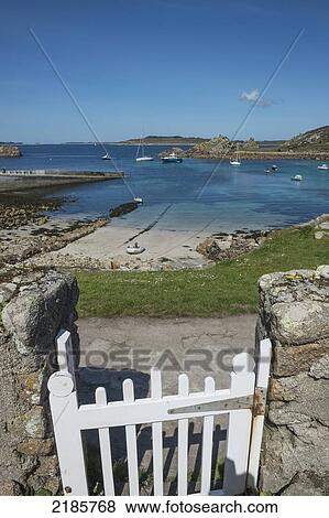 Stock Photo - White Gate Leading Out To The Beach And Quayside At St Agnes, Isles Of Scilly, Cornwall, Uk, Europe. Fotosearch