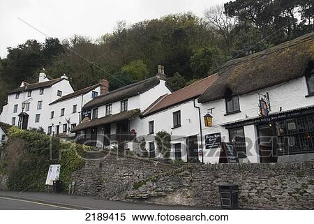 Stock Photography - White Row Houses With Thatched Roofs In Lynmouth, Exmoor, United Kingdom. Fotosearch
