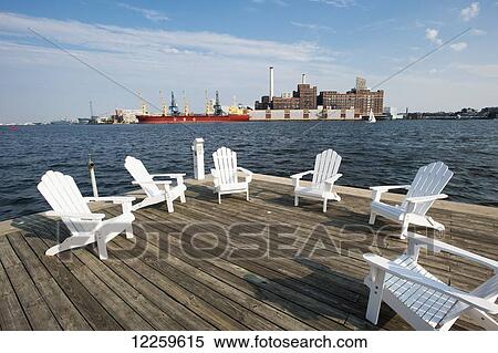 White wooden chairs on a deck by the Baltimore harbour, near Fells Point; Maryland, United States of America View Large Photo Image Stock Photography - White wooden chairs on a deck by the Baltimore harbour, near Fells Point; Maryland, United States of America. Fotosearch
