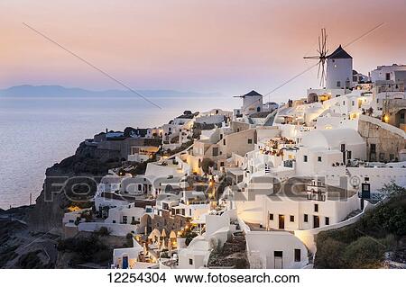 Whitewash buildings and windmill at dusk; Oia, Santorini, Greece View Large Photo Image Picture - Whitewash buildings and windmill at dusk; Oia, Santorini, Greece. Fotosearch