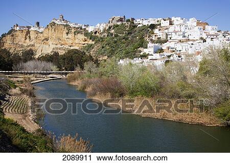 Whitewash Buildings In A Town And A Bridge Crossing A River; Arcos De La Frontera, Andalusia, Spain View Large Photo Image Stock Image - Whitewash Buildings In A Town And A Bridge Crossing A River; Arcos De La Frontera, Andalusia, Spain. Fotosearch
