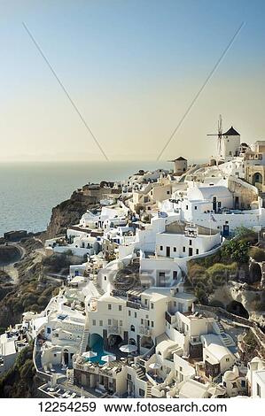 Stock Photo - Whitewash buildings on a hillside; Oia, Santorini, Greece. Fotosearch