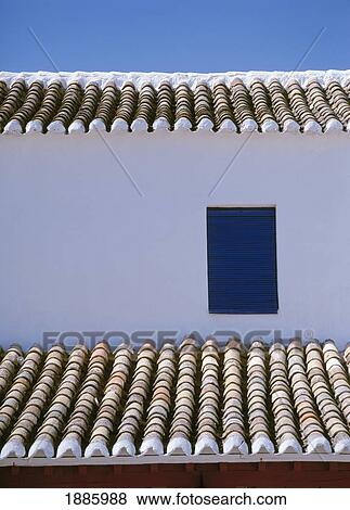 Stock Photo - Whitewashed Building With Tiles Roof And Window, Close Up. Fotosearch