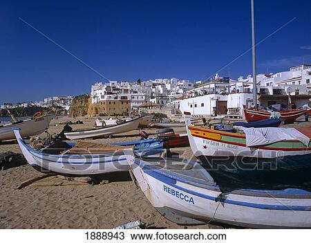 Stock Image - Whitewashed Buildings And Beach With Boats On Sand. Fotosearch