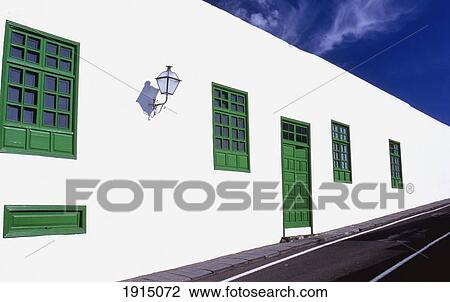 Stock Image - Whitewashed Wall & Painted Door. Fotosearch