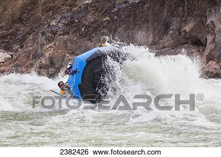 Stock Photograph - Whitewater raft flips when going through Crystal rapids on the Colorado River in the Grand Canyon National Park; Arizona, United States of America. Fotosearch