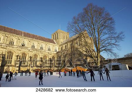 Stock Image - Winchester Cathedral ice rink for Christmas market; Winchester, Hampshire, England. Fotosearch