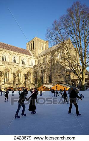 Stock Photo - Winchester Cathedral ice rink for Christmas market; Winchester, Hampshire, England. Fotosearch