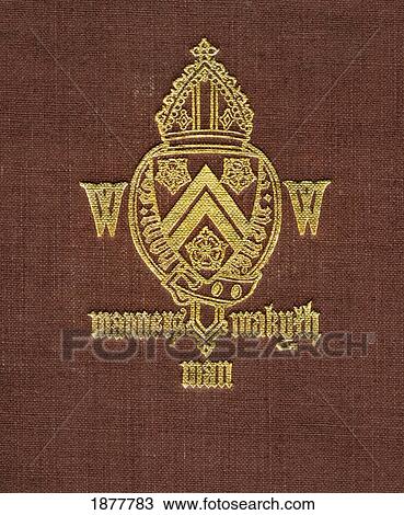 Stock Image - Winchester College Coat Of Arms And Motto. Manners Makyth Man. From Winchester College By Christopher Hawkes, Published By Country Life Limited, London, 1933.. Fotosearch