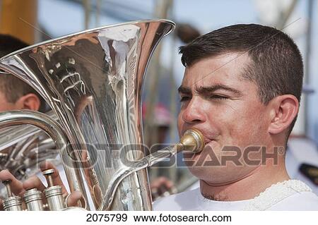 Stock Photo - Wind Instrument Player Of The Navy Band Performing On Board Of The Four-Mast Barquentine, Chilean Navy Training Ship Esmeralda In Hanga Roa Harbour, Rapa Nui (Easter Island), Chile. Fotosearch