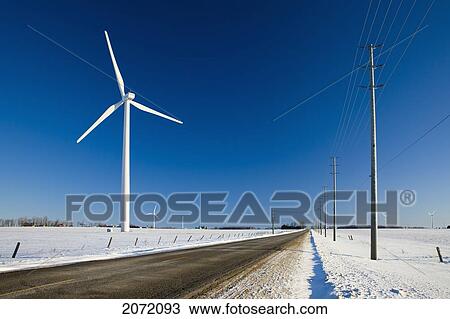 Stock Image - Wind Turbines Along Rural Road In Winter, Dufferin County, Ontario. Fotosearch
