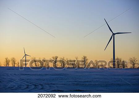 Stock Image - Wind Turbines At Sunrise In Winter, Dufferin County, Ontario. Fotosearch