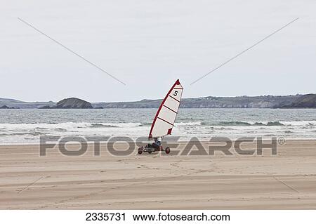Stock Image - Wind Yacht Speeding On Sand On Newgale Beach Along Pembrokeshire Coast Path Near St David's; Wales, Uk. Fotosearch