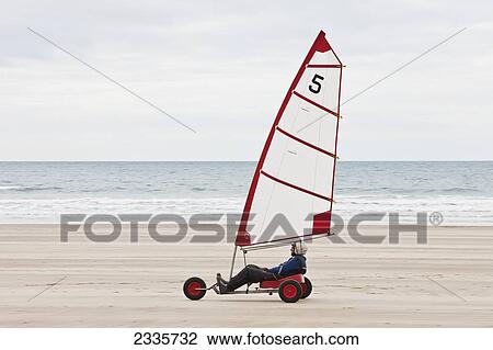 Stock Image - Wind Yacht Speeding On Sand On Newgale Beach Along Pembrokeshire Coast Path Near St David's; Wales, Uk. Fotosearch