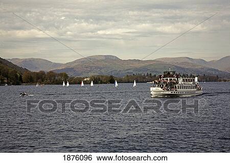 Windermere, Cumbria, England; A Steamer Boat Traveling With Passengers In Lake District National Park View Large Photo Image Stock Photograph - Windermere, Cumbria, England; A Steamer Boat Traveling With Passengers In Lake District National Park. Fotosearch
