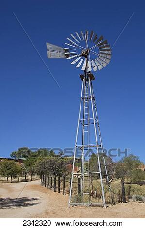Stock Image - Windmill With Fence; Namibia. Fotosearch