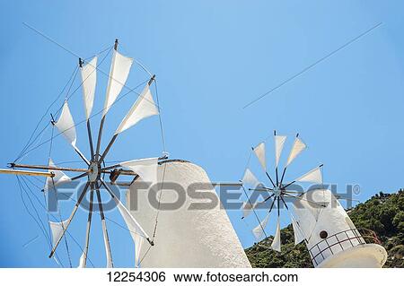 Windmills against a blue sky, Lasithi Plateau; Crete, Greece View Large Photo Image Stock Photograph - Windmills against a blue sky, Lasithi Plateau; Crete, Greece. Fotosearch