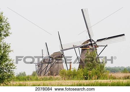 Windmills, Built Around 1740 Along Nieuwe Waterschap To Drain The Excess Water From The Alblasserwaard Polders, Kinderdijk, Netherlands View Large Photo Image Picture - Windmills, Built Around 1740 Along Nieuwe Waterschap To Drain The Excess Water From The Alblasserwaard Polders, Kinderdijk, Netherlands. Fotosearch