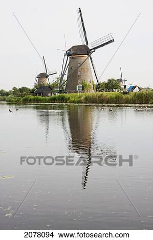 Picture - Windmills, Built Around 1740 To Drain The Excess Water From The Alblasserwaard Polders, Reflected In Nieuwe Waterschap, Kinderdijk, Netherlands. Fotosearch