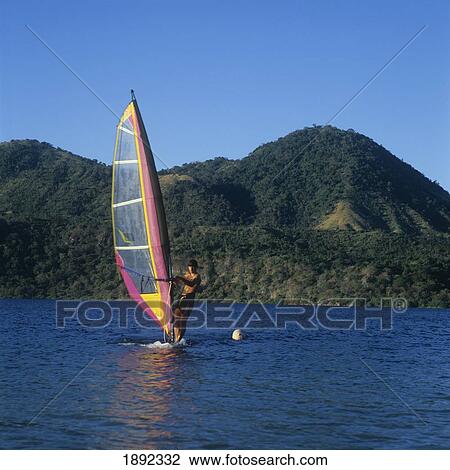 Stock Image - Windsurfer On Volcanic Lake. Fotosearch