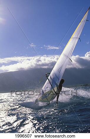 Windsurfing off the coast of an Hawaiian island; Hawaii, United States of America View Large Photo Image Stock Photo - Windsurfing off the coast of an Hawaiian island; Hawaii, United States of America. Fotosearch