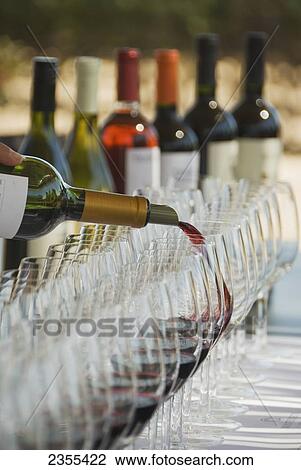 Wine Glasses And Bottles At An Outdoor Wine Tasting; Mendoza, Argentina View Large Photo Image Stock Image - Wine Glasses And Bottles At An Outdoor Wine Tasting; Mendoza, Argentina. Fotosearch