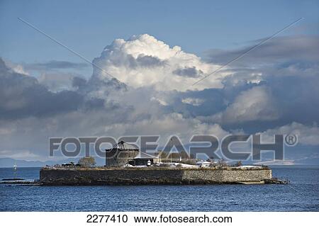 Stock Image - Winter snow scene of the notorious prison island and later monastery of Munkholmen; Trondheim, Norway. Fotosearch