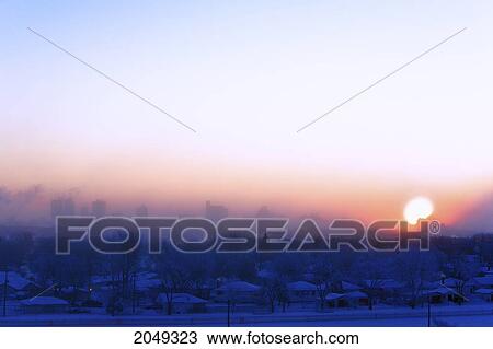 Stock Image - Winter Sunrise And Fog, Over Downtown Skyline, Winnipeg, Manitoba. Fotosearch