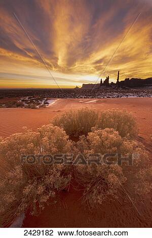 Stock Image - Winter sunrise over totem formation in Monument Valley Navajo Tribal Park; Arizona, United States of America. Fotosearch