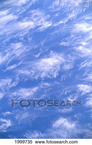 Stock Photography - Wispy Clouds Over Pale Blue Skies C1705. Fotosearch