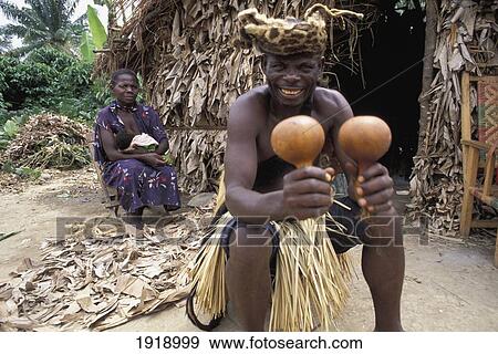Witch Doctor Sitting Outside Hut; Uganda View Large Photo Image Stock Photo - Witch Doctor Sitting Outside Hut; Uganda. Fotosearch