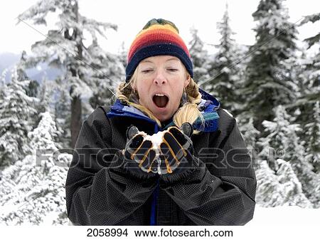 Woman About To Blow A Handful Of Snow At Hollyburn Peak, Cypress Provincial Park, B. C., Canada View Large Photo Image Picture - Woman About To Blow A Handful Of Snow At Hollyburn Peak, Cypress Provincial Park, B. C., Canada. Fotosearch