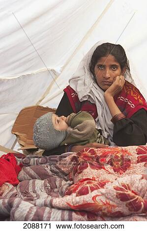 Stock Image - Woman And Baby In A Relief Camp Tent After The 8 October 2005 Earthquake, Bagh, Azad Kashmir, Pakistan. Fotosearch