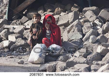 Woman And Boy By The Rubble Of A Building Destroyed By The 8 October 2005 Earthquake, Muzaffarabad, Azad Kashmir, Pakistan View Large Photo Image Stock Image - Woman And Boy By The Rubble Of A Building Destroyed By The 8 October 2005 Earthquake, Muzaffarabad, Azad Kashmir, Pakistan. Fotosearch