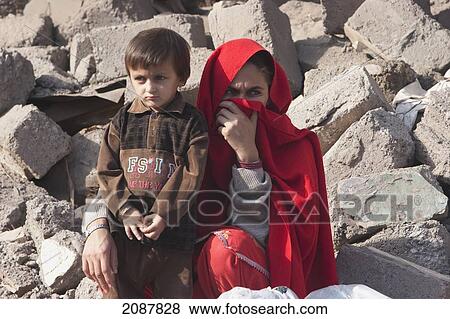 Woman And Boy By The Rubble Of A Building Destroyed By The 8 October 2005 Earthquake, Muzaffarabad, Azad Kashmir, Pakistan View Large Photo Image Stock Photo - Woman And Boy By The Rubble Of A Building Destroyed By The 8 October 2005 Earthquake, Muzaffarabad, Azad Kashmir, Pakistan. Fotosearch