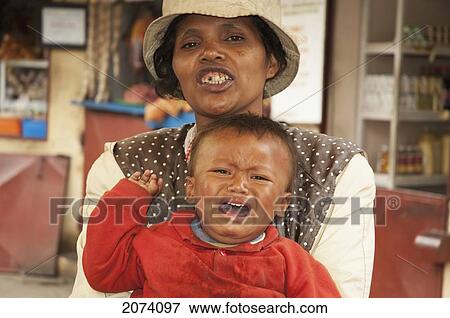 Woman And Her Crying Boy At An Antananarivo Market, Antananarivo Province, Madagascar View Large Photo Image Stock Photo - Woman And Her Crying Boy At An Antananarivo Market, Antananarivo Province, Madagascar. Fotosearch