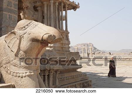 Stock Image - Woman And Sculpture Of Elephant At Vittala Temple In Hampi. Fotosearch