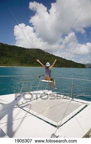 Stock Photo - Woman At Rear Of Sailboat. Fotosearch