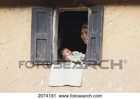 Woman & Baby In A House Along The Road Between Ambositra & Ambavalao, Fianarantsoa Province, Madagascar View Large Photo Image Stock Image - Woman & Baby In A House Along The Road Between Ambositra & Ambavalao, Fianarantsoa Province, Madagascar. Fotosearch