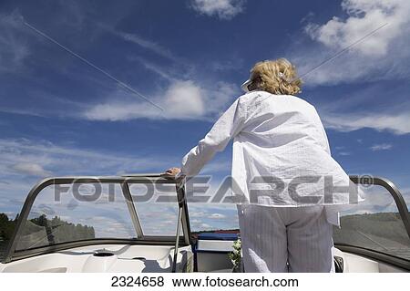 Stock Photo - Woman Boating On A Sunny Morning, Ontario, Canada. Fotosearch