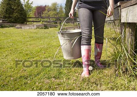 Woman Carries Pail With Rubber Boots. Langley Bc View Large Photo Image Stock Image - Woman Carries Pail With Rubber Boots. Langley Bc. Fotosearch