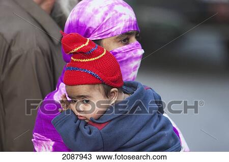 Woman Carrying A Baby After The 8 October 2005 Earthquake, Muzaffarabad, Azad Kashmir, Pakistan View Large Photo Image Stock Image - Woman Carrying A Baby After The 8 October 2005 Earthquake, Muzaffarabad, Azad Kashmir, Pakistan. Fotosearch