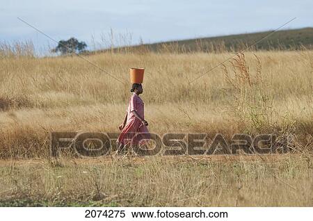 Stock Photography - Woman Carrying A Basket Near Soamadio, Fianarantsoa Province, Madagascar. Fotosearch