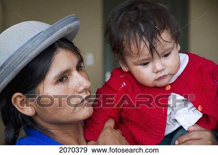 Woman Carrying A Boy At The Festivities Of The D View Large Photo Image Stock Photo - Woman Carrying A Boy At The Festivities Of The D. Fotosearch