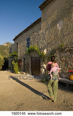 Woman Carrying Baby Slung On Back Past Finca Es Castell Near Binibona, Majorca, Spain View Large Photo Image Stock Photography - Woman Carrying Baby Slung On Back Past Finca Es Castell Near Binibona, Majorca, Spain. Fotosearch