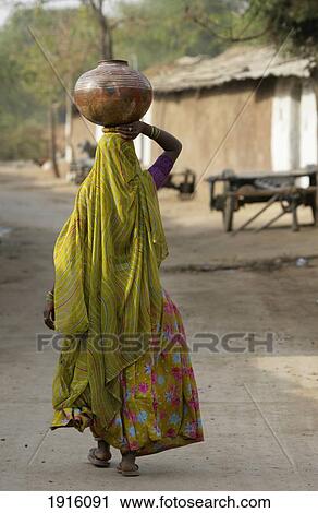Woman Carrying Jug On Head View Large Photo Image Stock Image - Woman Carrying Jug On Head. Fotosearch