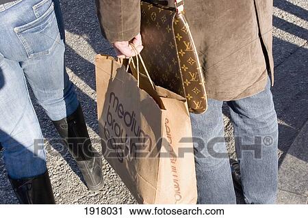 Woman Carrying Paper Shopping Bag View Large Photo Image Stock Image - Woman Carrying Paper Shopping Bag. Fotosearch